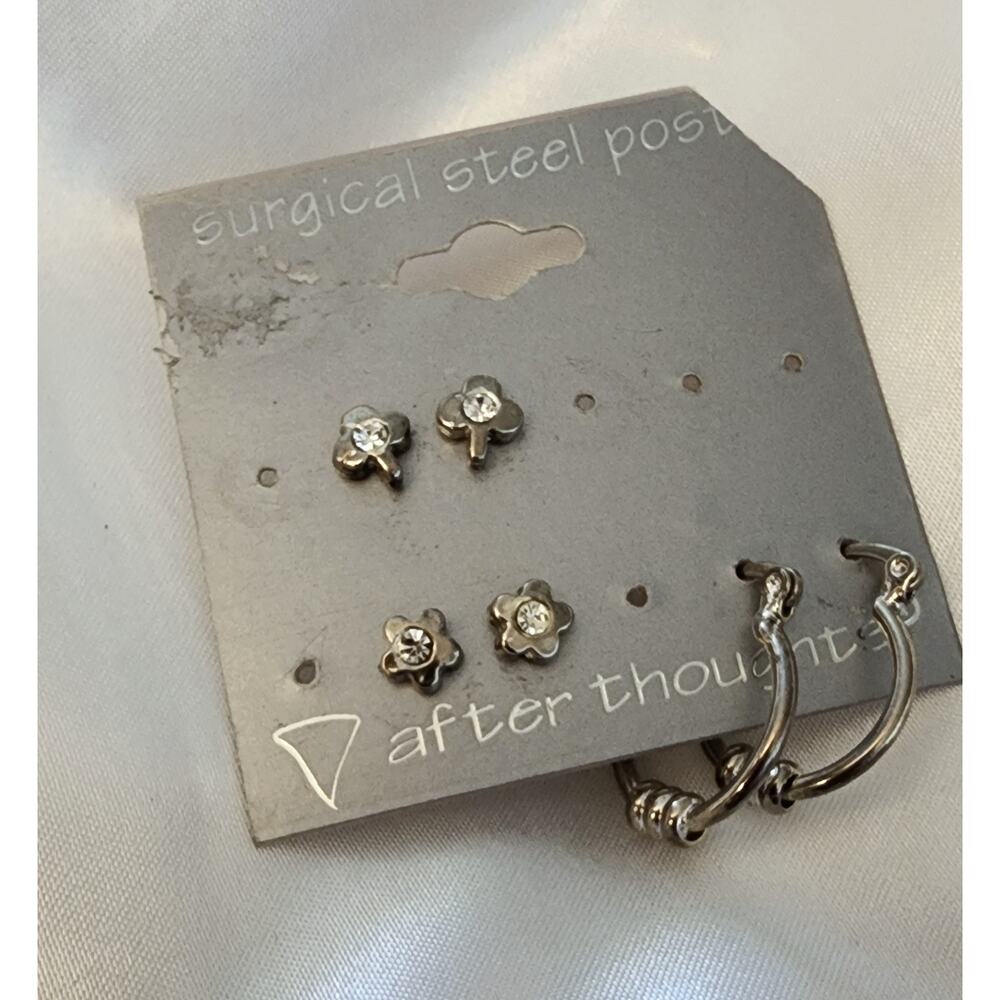 Three pair stainless steel earrings shamrock, flowers, and hoops